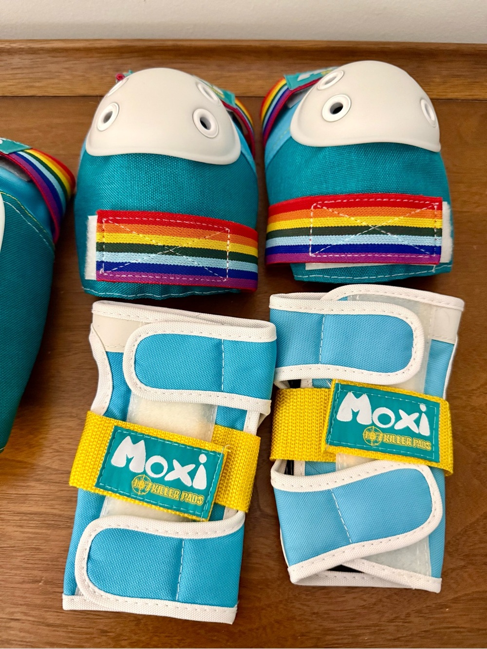 Moxi Roller Skates Teal Wrist, Elbow, and Knee Pad Set with Rainbow Accents